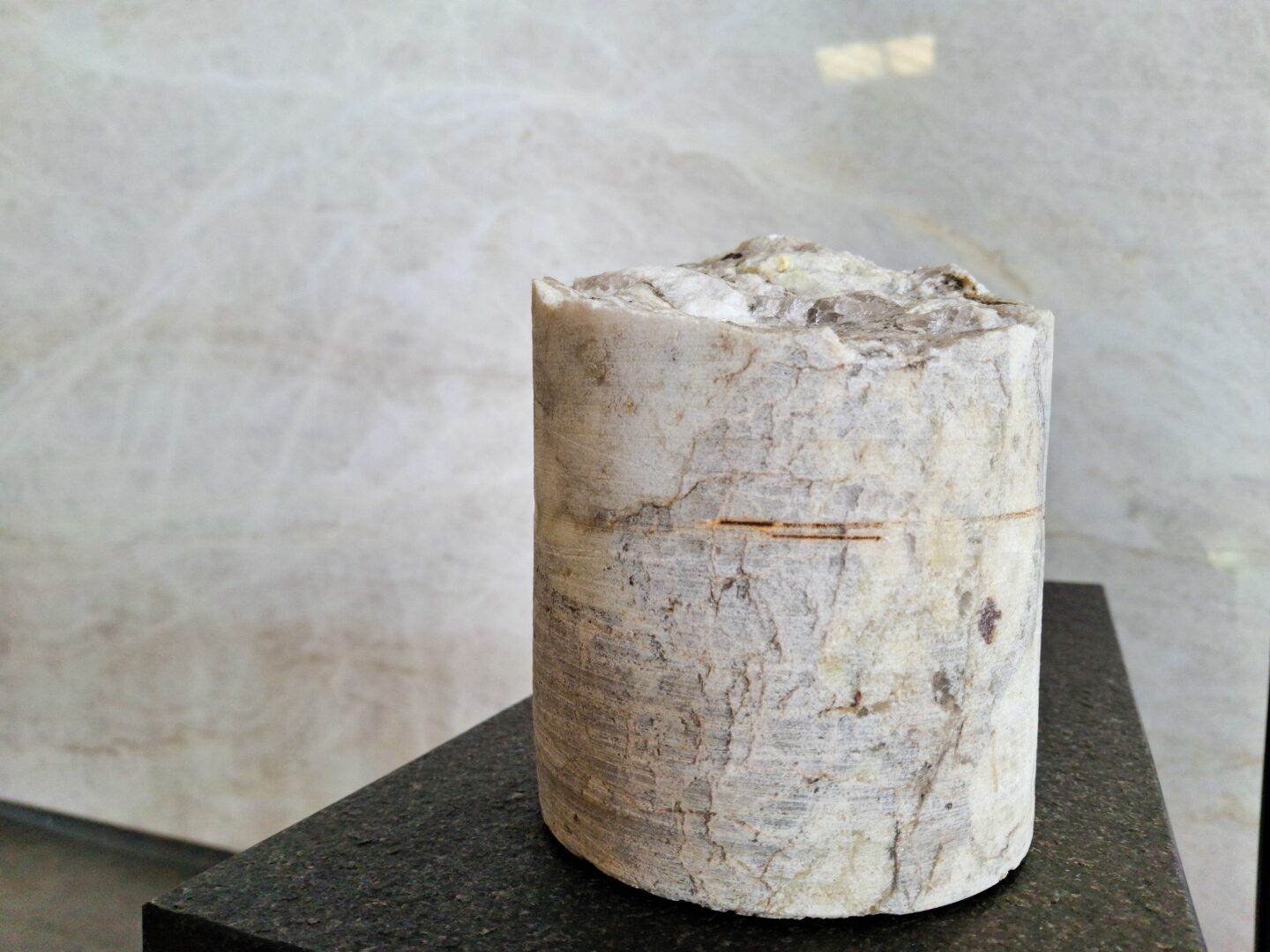 Granite type cylinder on a texted granite table. 